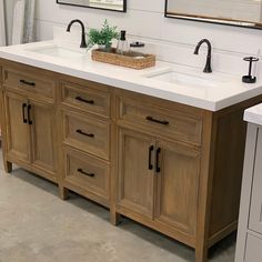 a bathroom with two sinks and mirrors on the wall