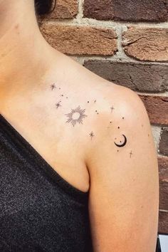 a woman's upper arm with stars and the moon on it