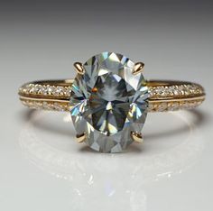 an engagement ring with a large diamond in the center and two rows of diamonds on each side