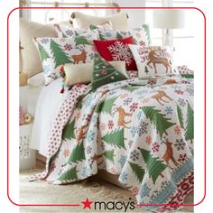 a bed covered in christmas themed sheets and pillows