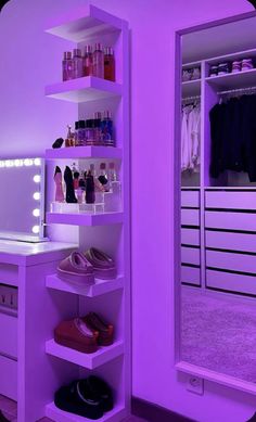 a closet with purple lighting and shoes on the shelves in front of a large mirror