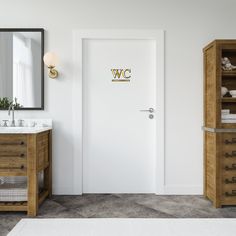 a bathroom with two sinks and a large mirror on the wall next to an open door