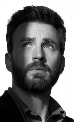 a black and white photo of a man with a beard