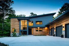 a modern house with two garages in the front and one on the other side