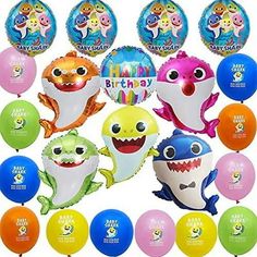 a bunch of balloons that have different types of animals on them, and some are in the shape of shark