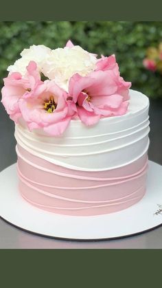 a white cake with pink and white flowers on top