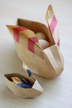 an origami bird made out of brown paper