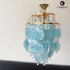 a blue chandelier hanging from a ceiling