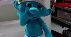 a blue stuffed animal wearing a white hat