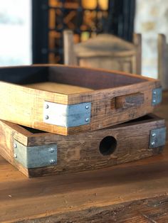 two wooden boxes sitting on top of a table