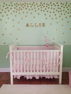 a baby's room decorated in pink and gold