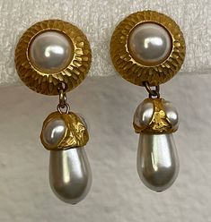 "Clara Studio Inc matte gold  faux pearl dangle, drop earrings.  Very good condition  size - 1 7/8\" x 3/4\"  1 earring marked: Copyright symbol Clara studio Inc  Domestic shipping: USPS First class mail. 1-5 business days. I can file an insurance claim only after 20 business days after item was shipped International shipping: USPS First class mail. Approximately 7-21 business days. I can file an insurance claim only after 40 business days after item was shipped. I can not refund your money unti Copyright Symbol, Brighton Bracelets, Insurance Claim, Gold Satin, Cat Brooch, Gold Plated Chains, Clear Rhinestones, Matte Gold, First Class