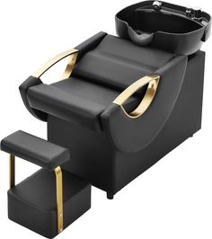 a black chair with gold trimmings and a bowl on the back of it