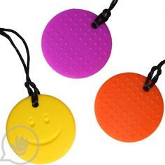 three different colored round tags with black string