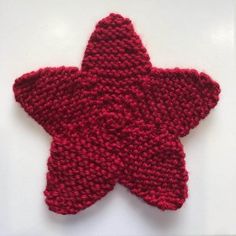 a red knitted star on a white surface