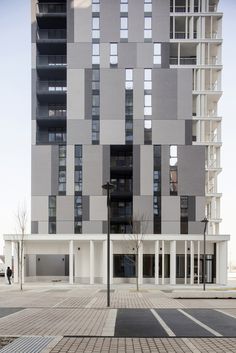 a tall building with lots of windows next to a street