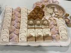 a table topped with lots of different types of cookies and candies covered in frosting