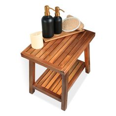 a wooden table with two soap dispensers on it and a white plate next to it