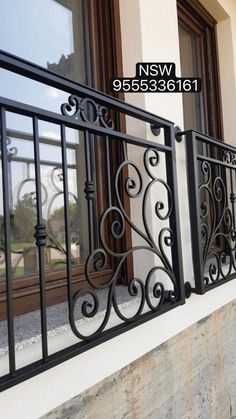 an iron balcony railing on the side of a building