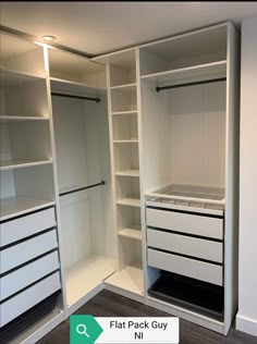 an empty walk in closet with white shelves and drawers on one side, the other half closed