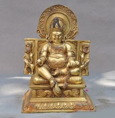 a golden buddha statue sitting on top of a table