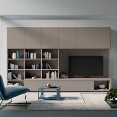 a living room filled with furniture and a flat screen tv on top of a wall