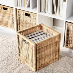 a wicker basket sitting on the floor in front of bookshelves