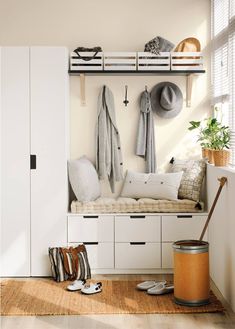 a room with some white cupboards and hats