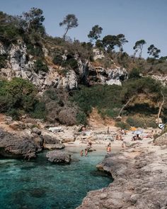 people are swimming in the clear blue water