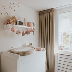 a baby's room with a crib and toys on the shelf above it