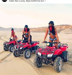 three women riding four wheelers in the desert