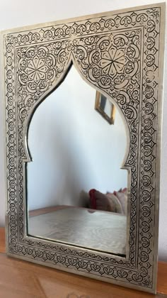 a mirror that is sitting on top of a table