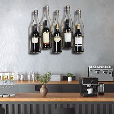 several bottles of wine are hanging on the wall