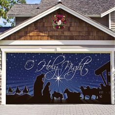 a garage door decorated with an image of the birth of jesus and nativity scene