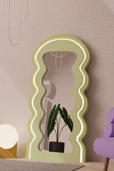 a mirror with a plant in it next to a purple chair and lamp on the floor