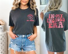 two women wearing t - shirts that say i'm my engaged era, and one has her back to the camera