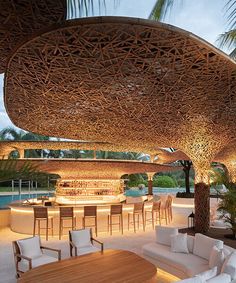 an outdoor bar with white couches and tables