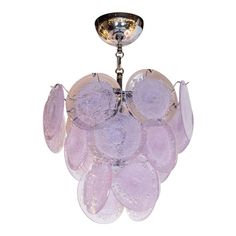 a purple chandelier hanging from a ceiling fixture with glass petals on the bottom