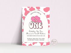 a pink and white polka dot pattern with the word one on it is in front of a