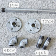 an assortment of pipe fittings and fitting tools laid out on the carpeted floor