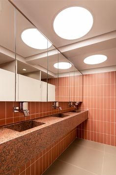 a public restroom with two sinks and mirrors