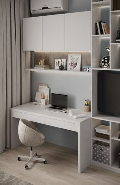 a white desk with a computer on it in front of a bookcase and bookshelf