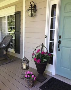 the front porch is decorated with flowers and lanterns