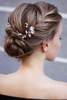 a woman wearing a hair comb with flowers in it