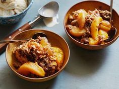 two bowls filled with food sitting on top of a table next to a bowl of ice cream