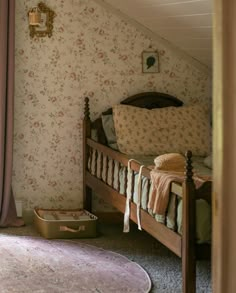 a bedroom with floral wallpaper and bedding in an attic style room that has carpeted flooring