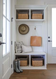 the entryway is clean and organized with baskets, boots, and hats on shelves