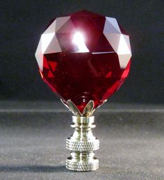 a large red diamond sitting on top of a metal stand