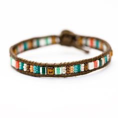 a brown leather bracelet with multi colored beads