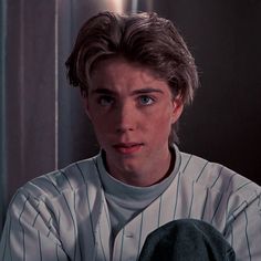 a young man in a baseball uniform making a surprised face